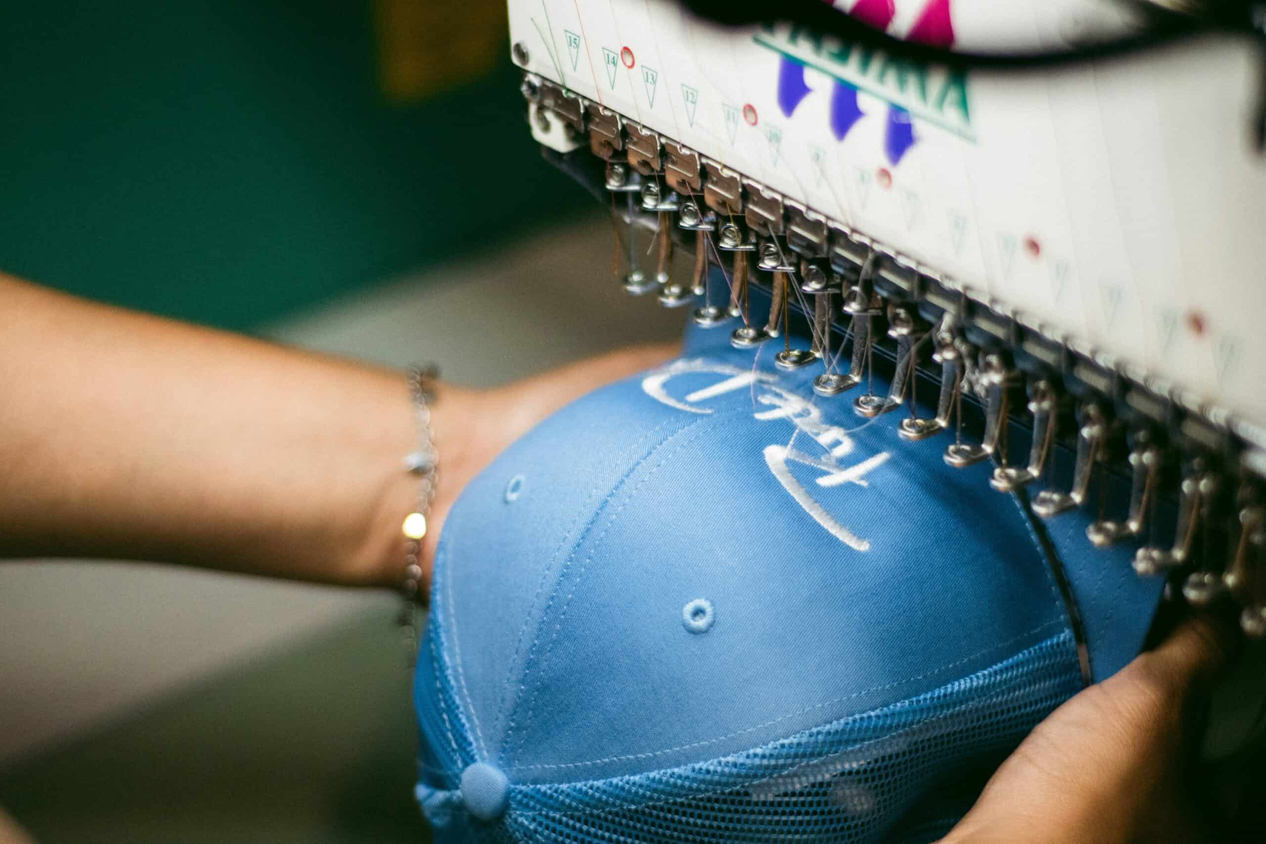 promotional blue cap being embroidered